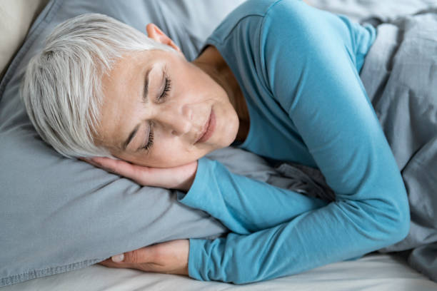 Beautiful Peaceful Mature Woman Sleeping in Bed Beautiful Peaceful Mature Woman Sleeping in Bed